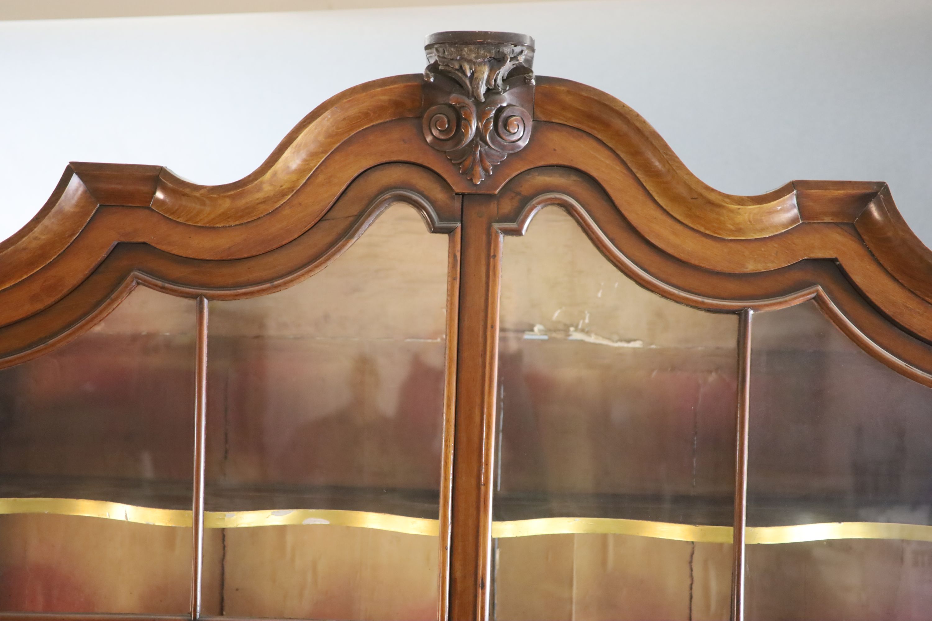 A late 18th century Dutch walnut serpentine vitrine, W.5ft 11in. D.1ft 4in. H.8ft 5in.